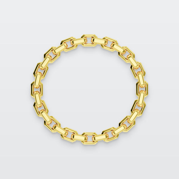 Box Chain Bracelet in solid gold, photographed flat on a pale grey studio surface