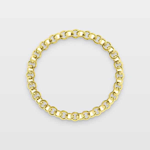 Circle Chain Bracelet in solid gold, photographed flat on a pale grey studio surface
