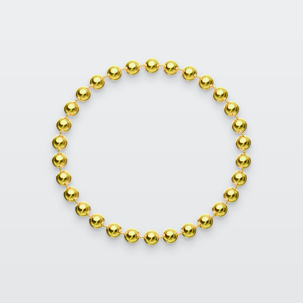 Ball Chain Bracelet in solid gold, photographed flat on a pale grey studio surface