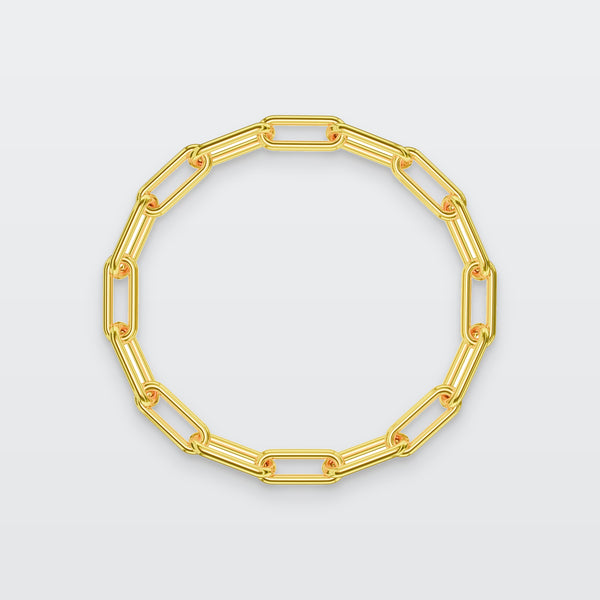 Paperclip Chain Bracelet in solid gold, photographed flat on a pale grey studio surface